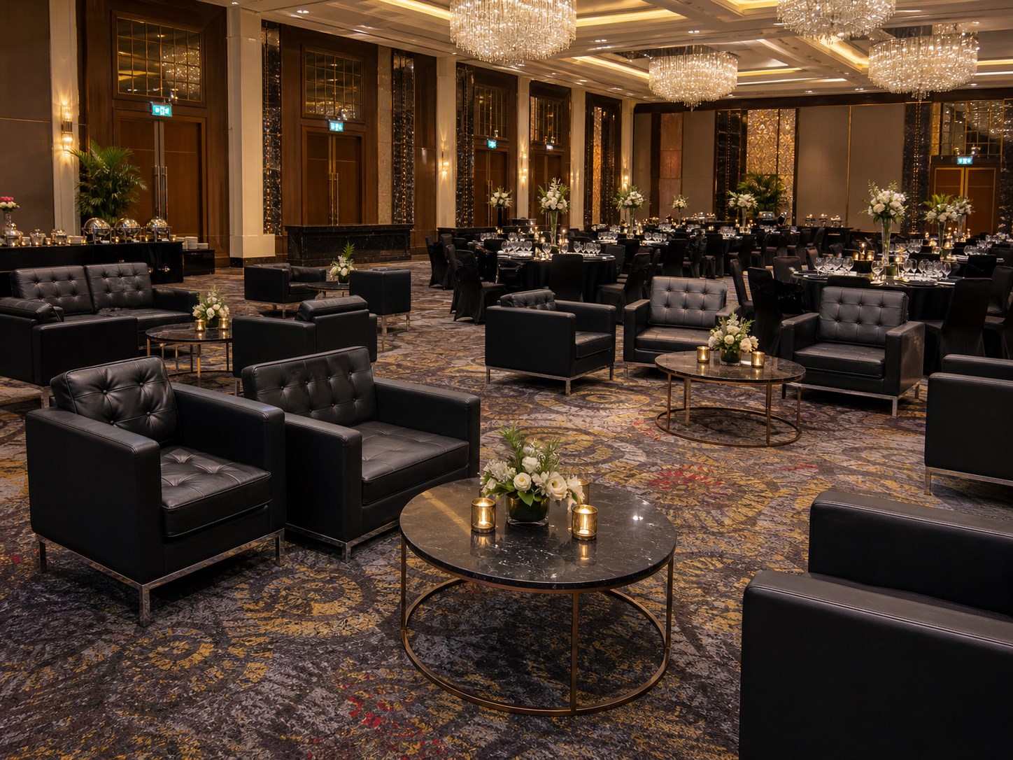 Black leather sofa lounge clusters with coffee tables in a luxury ballroom setup