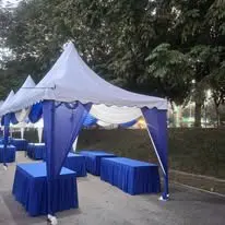 Blue canopy outdoor setup with skirted tables