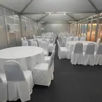 Canopy round table setup with white chair covers