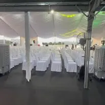 Canopy audience seating with white covered chairs