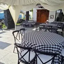 Checked table cloth setup with black event chairs