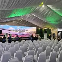 Conference chair setup under canopy facing stage