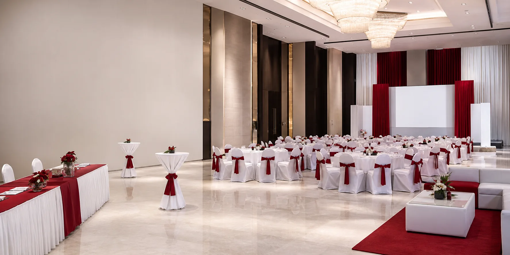 Premium red and white event furniture rental setup with banquet chairs and round tables