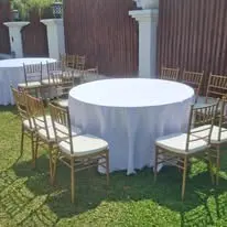 Lawn round table setup with gold Chiavari chairs