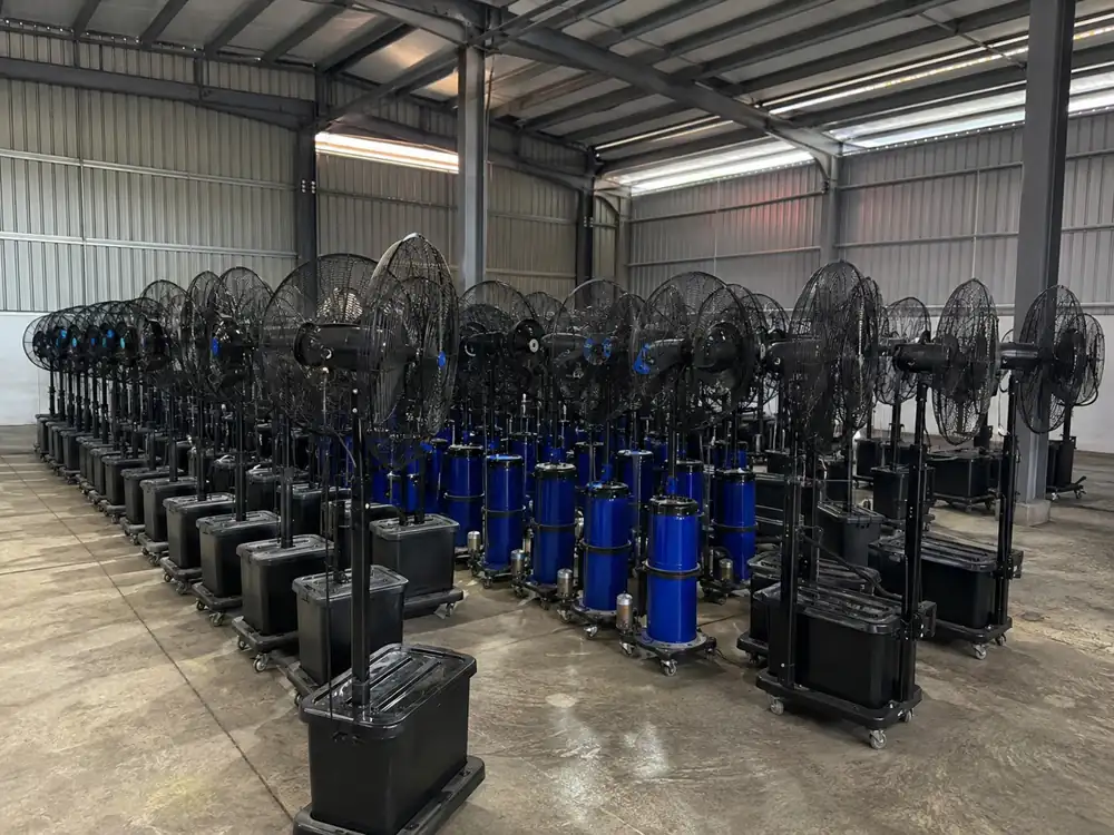 Mist fan rental units with blue water tanks arranged in warehouse stock