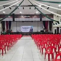 Red plastic chair hall setup facing stage