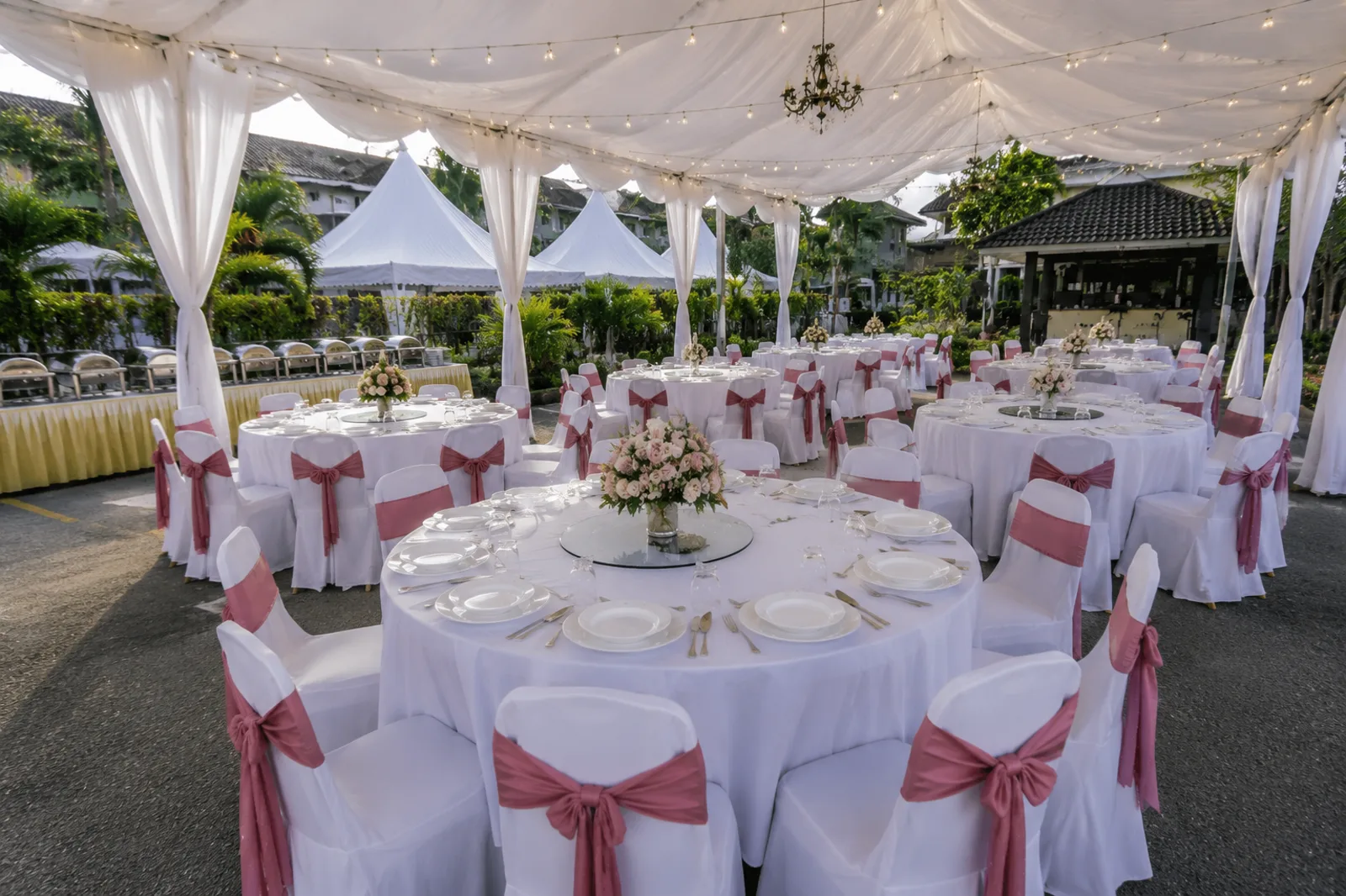 Canopy round table setup with white table cloth and pink chair sash